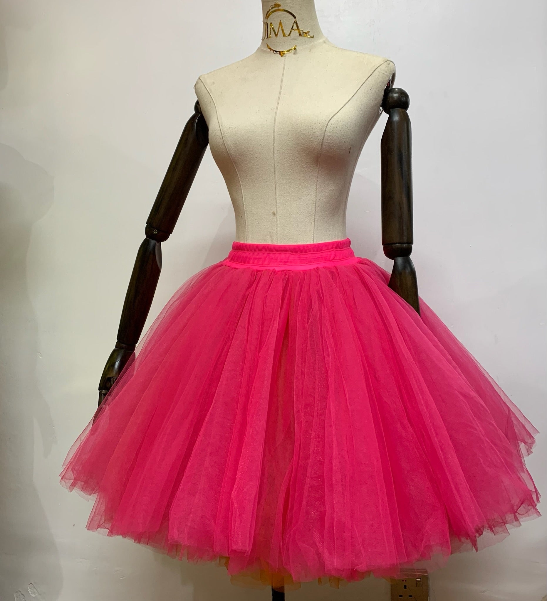 A fluffy tulle skirt in a soft pastel color, showcasing layers of delicate fabric for a whimsical and elegant look.