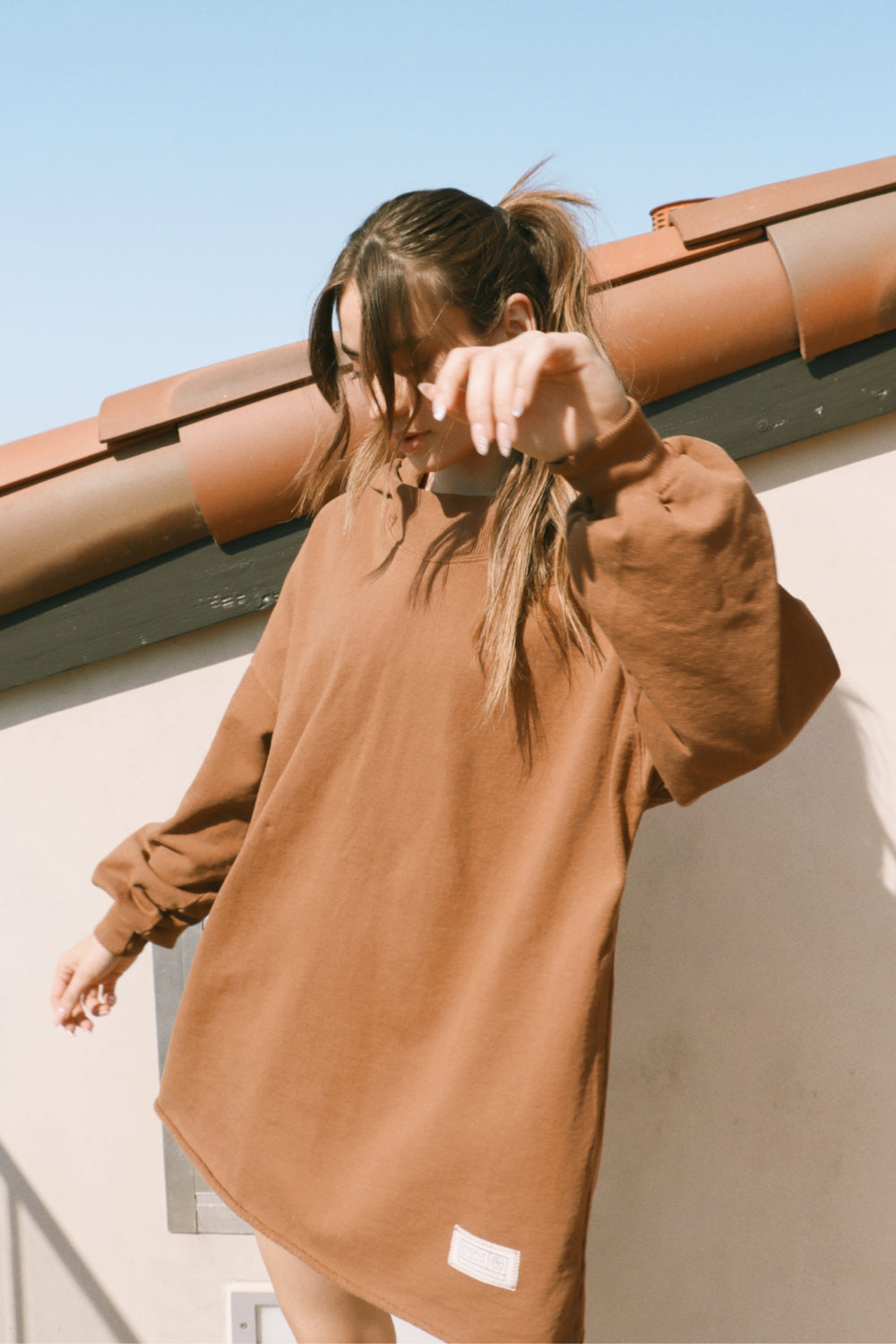 A cozy oversized bell-shaped hoodie in saddle color, made from 100% cotton, perfect for casual wear.