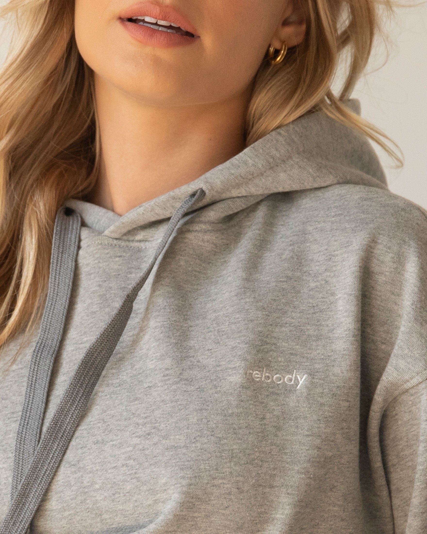 Rebody Lifestyle Hoodie in soft 100% cotton french terry fabric, featuring shoelace drawstrings and minimal branding.