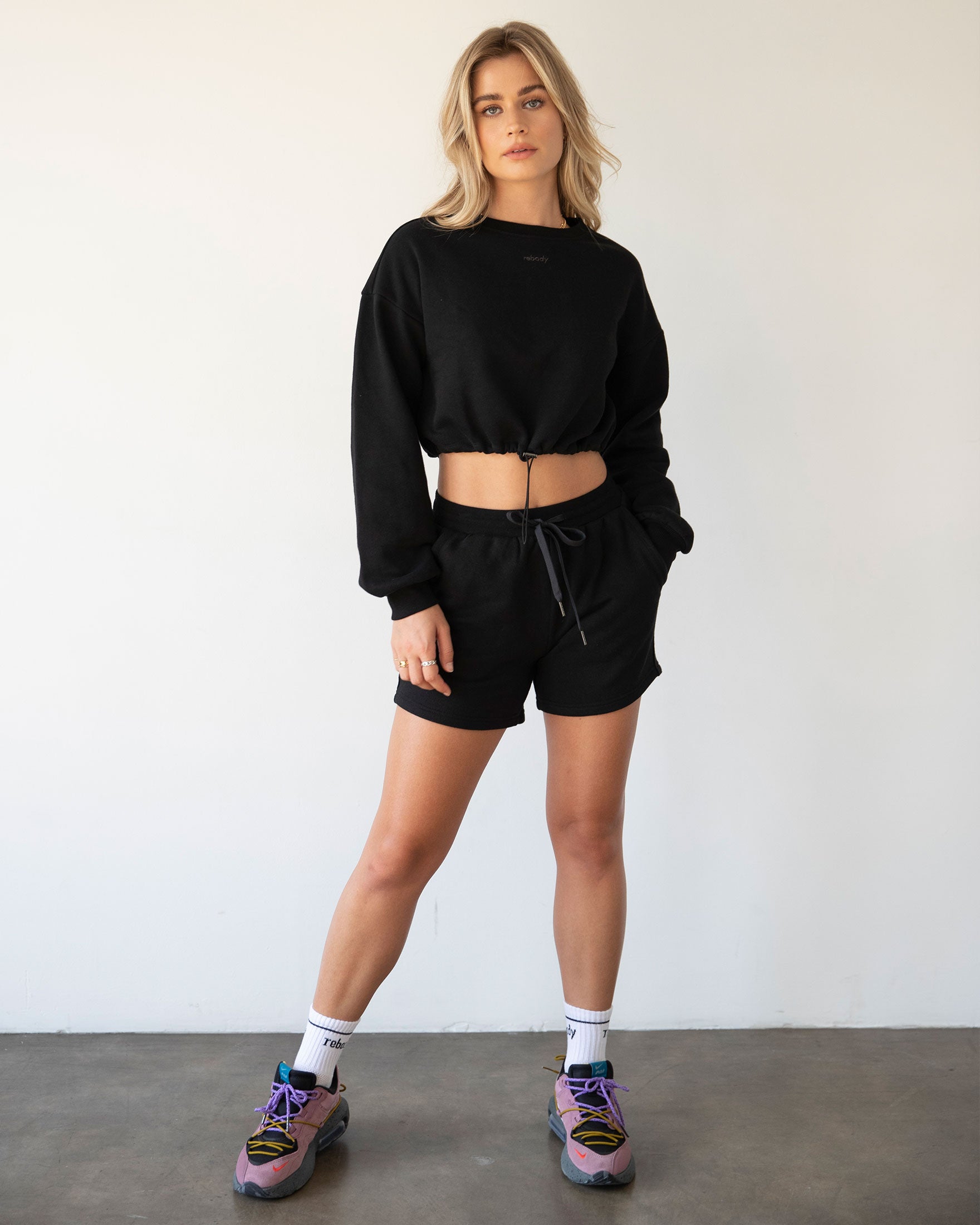 Rebody Puff Sleeve Crop Sweatshirt featuring a relaxed fit and slight bell sleeves, showcasing its unique design and embroidered branding.