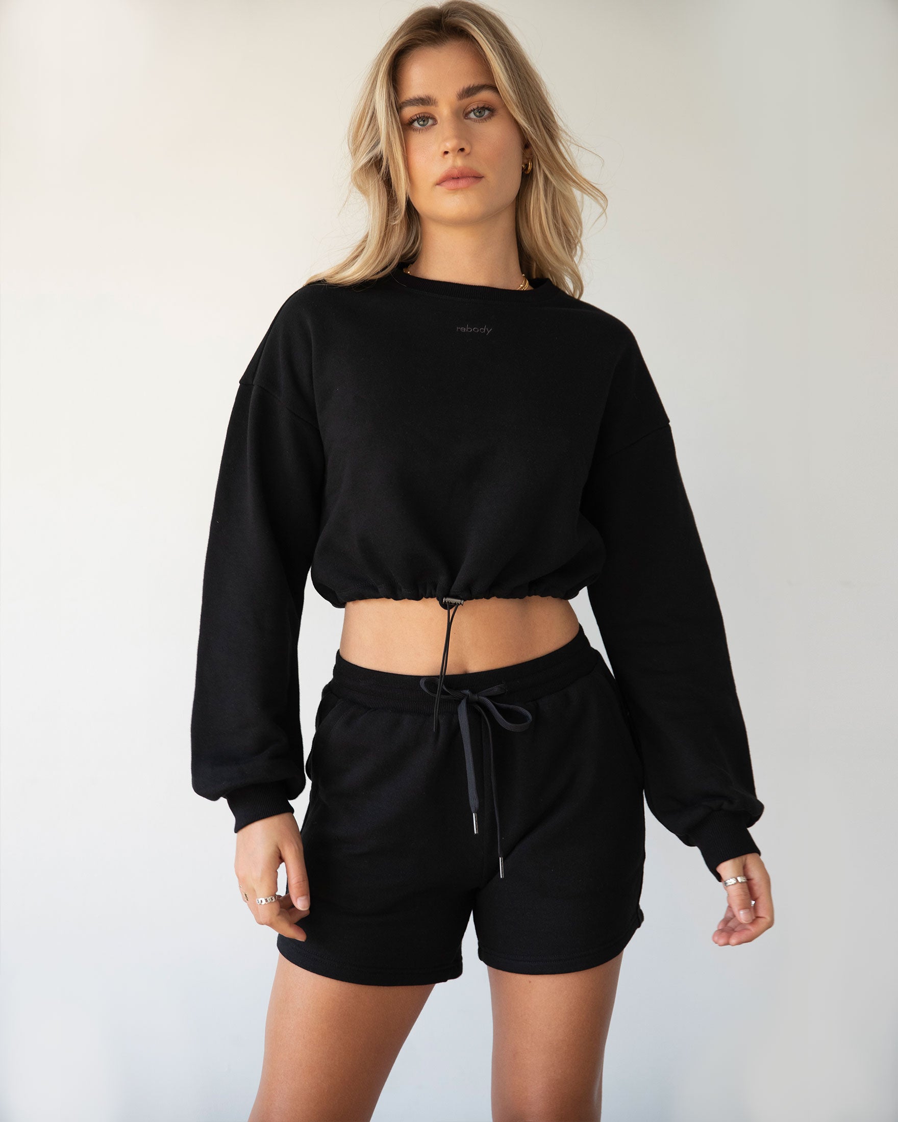 Rebody Puff Sleeve Crop Sweatshirt featuring a relaxed fit and slight bell sleeves, showcasing its unique design and embroidered branding.