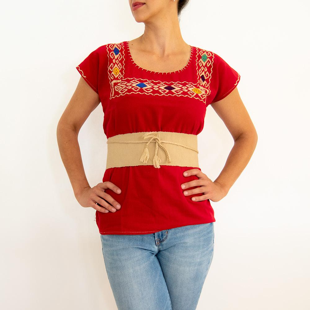 A vibrant red blouse huipil featuring colorful hand-stitched designs, showcasing traditional Mexican craftsmanship.