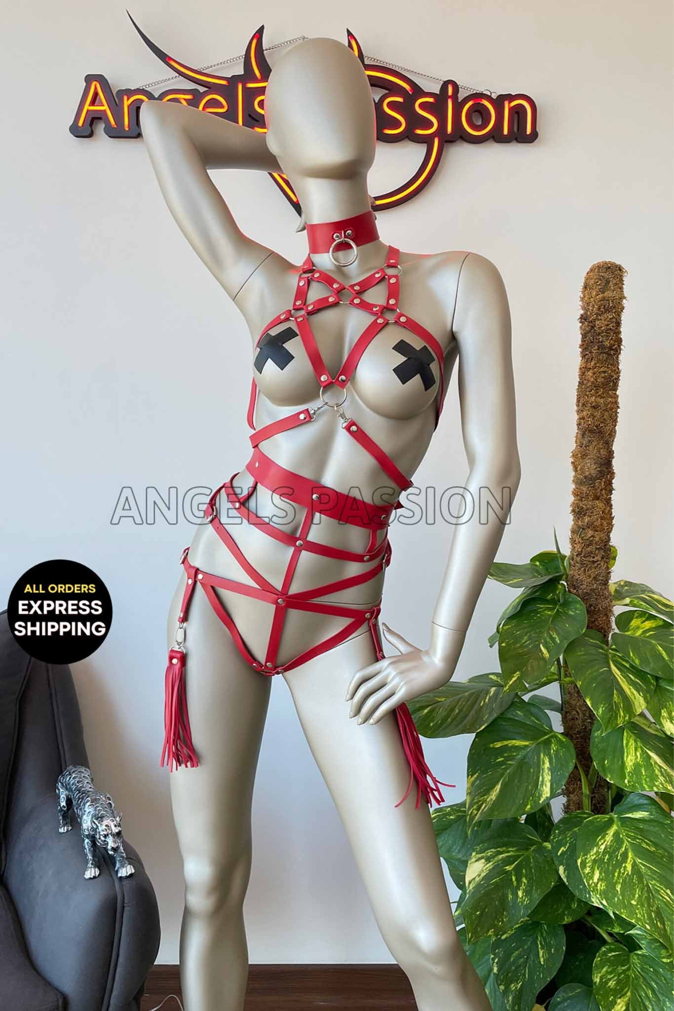 A stylish red vegan leather full body harness with intricate stitching, perfect for enhancing any outfit while promoting ethical fashion.