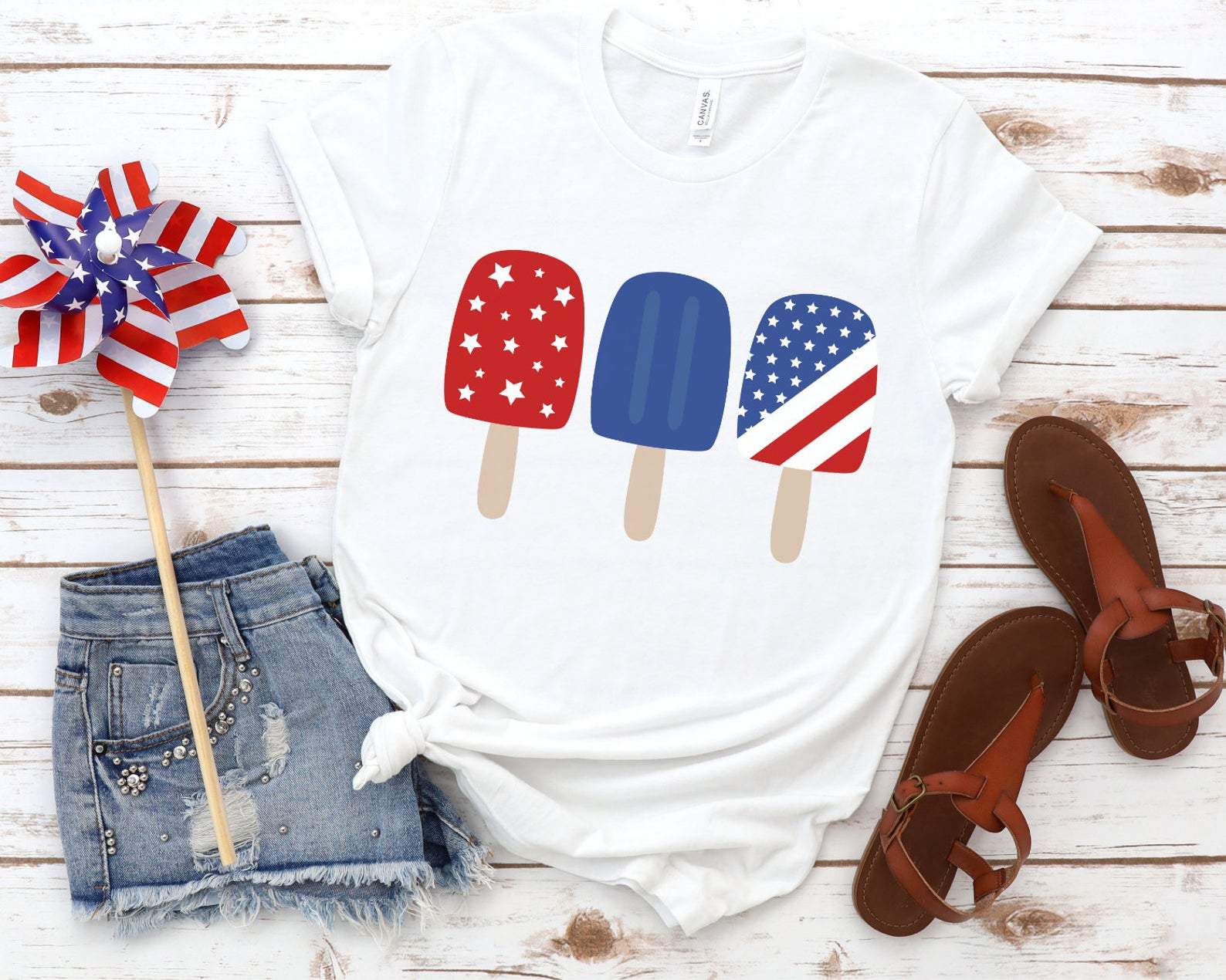 A vibrant Red White Blue Patriotic Popsicle Tee featuring a classic crew neck and short sleeves, perfect for summer celebrations.