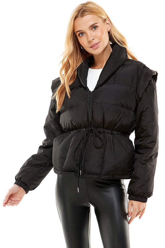 A stylish Removable Sleeve Puff Jacket with adjustable tie waist, showcasing its chic design and versatility.