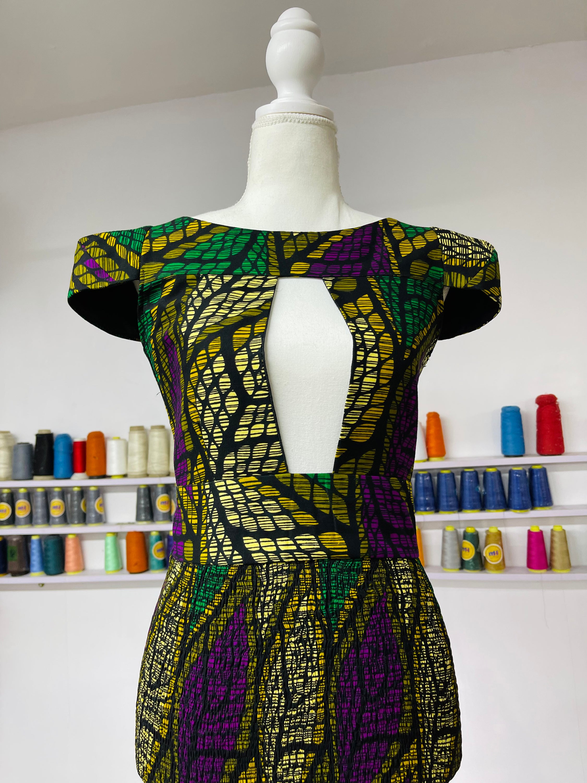 Rena Dress featuring vibrant African print design, showcasing intricate patterns and colors.