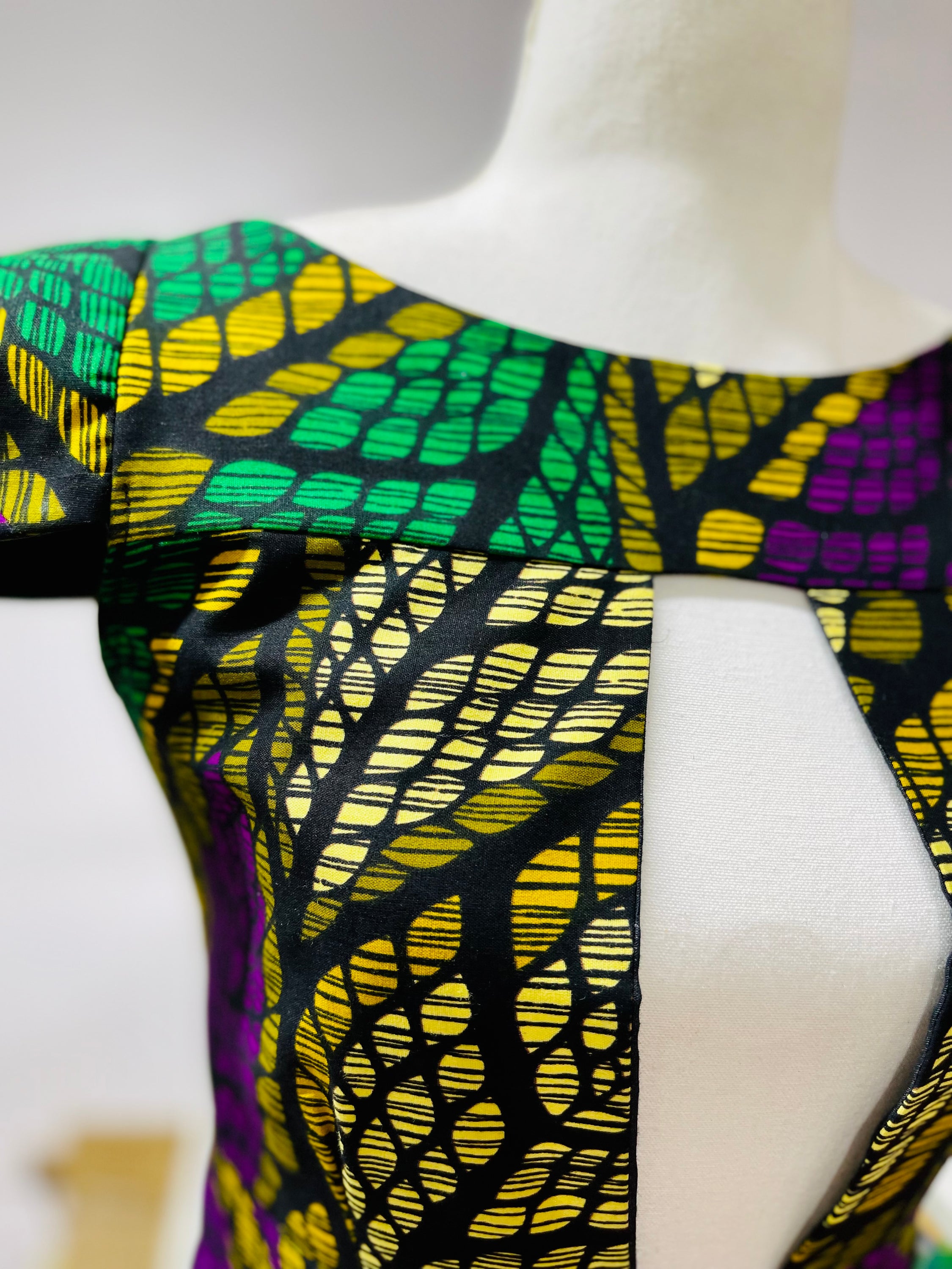 Rena Dress featuring vibrant African print design, showcasing intricate patterns and colors.