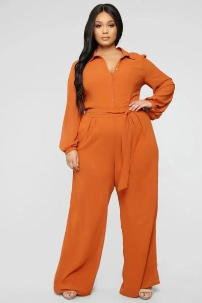 Rena Jumpsuit featuring an open chest design, long sleeves, and long pants in a solid color, perfect for stylish occasions.