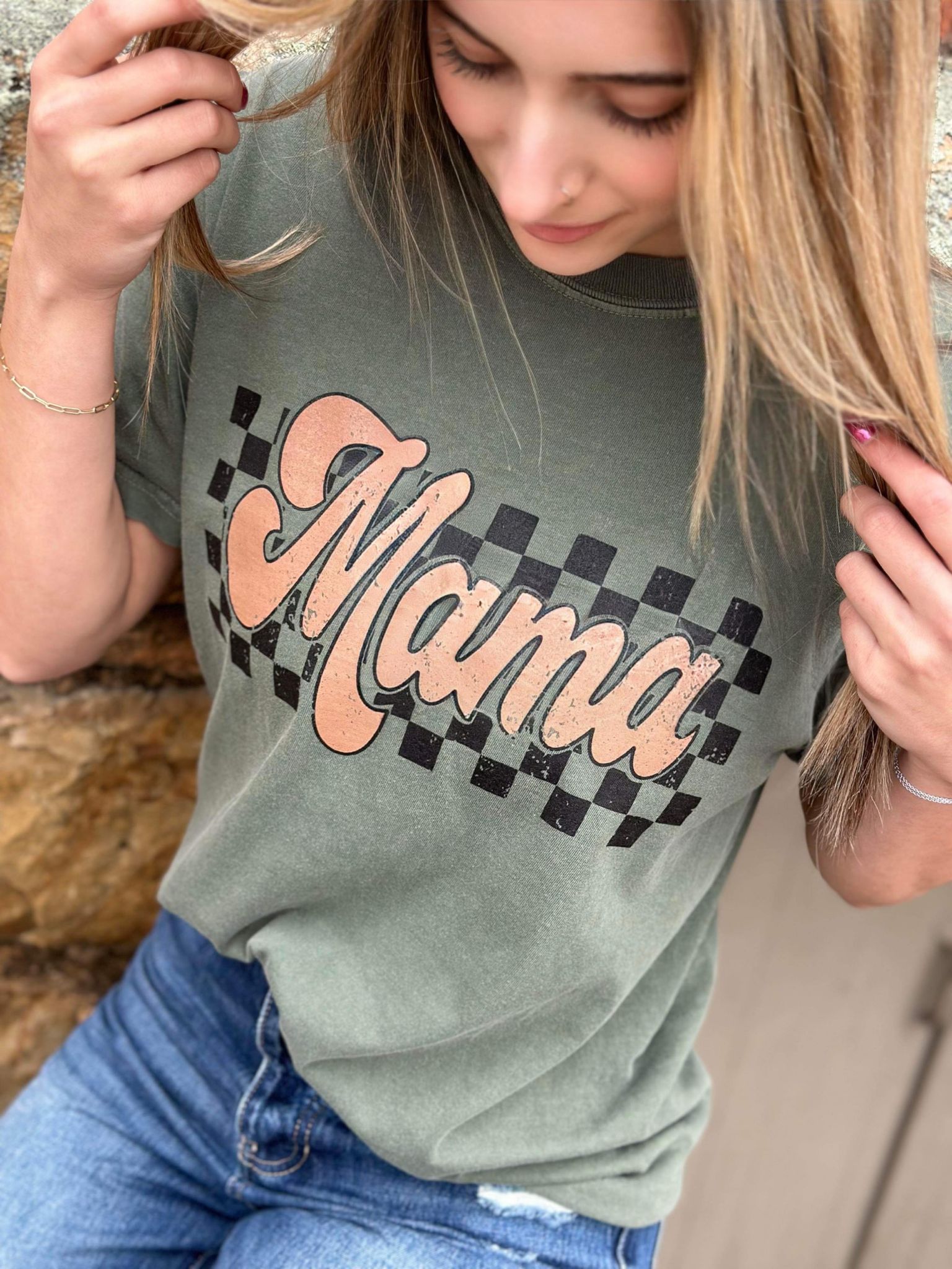 A stylish Retro Checkered Mama Tee in moss color, featuring a trendy checkered design, made from 100% cotton for comfort.