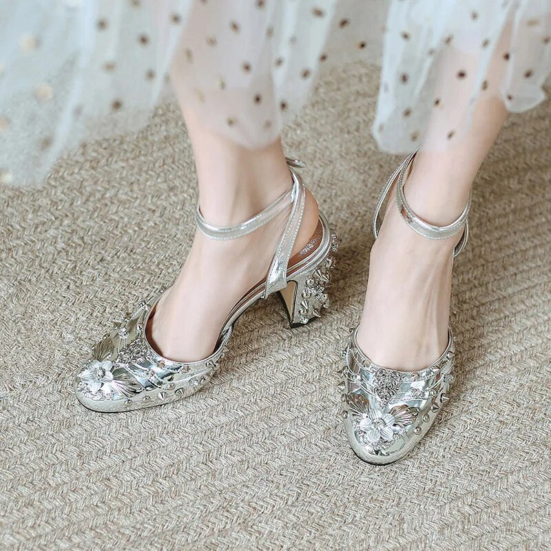 A pair of elegant Retro Rivet Gem Heels in gold and silver, showcasing a floral pattern and a super high 9.5CM heel, perfect for parties.