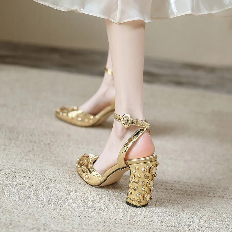 A pair of elegant Retro Rivet Gem Heels in gold and silver, showcasing a floral pattern and a super high 9.5CM heel, perfect for parties.