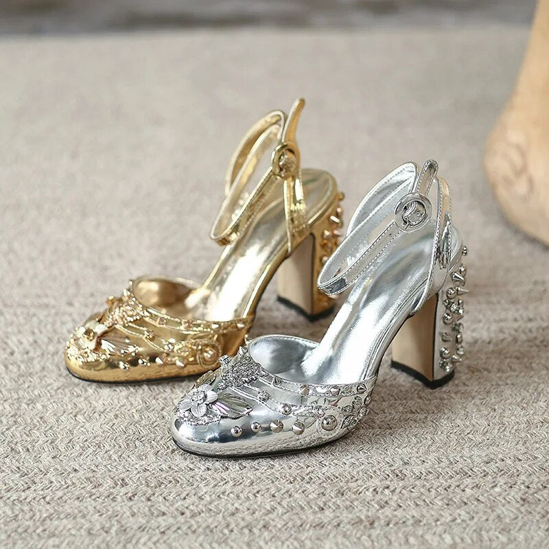 A pair of elegant Retro Rivet Gem Heels in gold and silver, showcasing a floral pattern and a super high 9.5CM heel, perfect for parties.