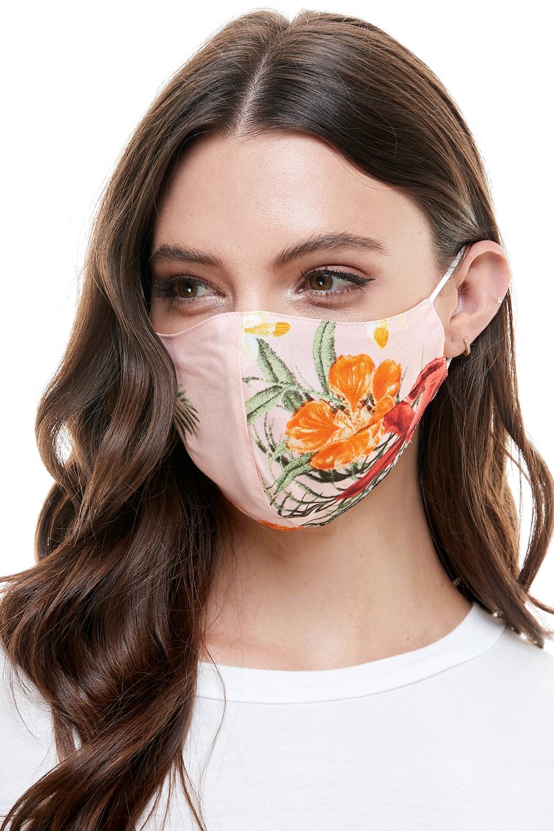 Reversible woven face mask featuring vibrant floral and tropical patterns, designed for comfort and safety.