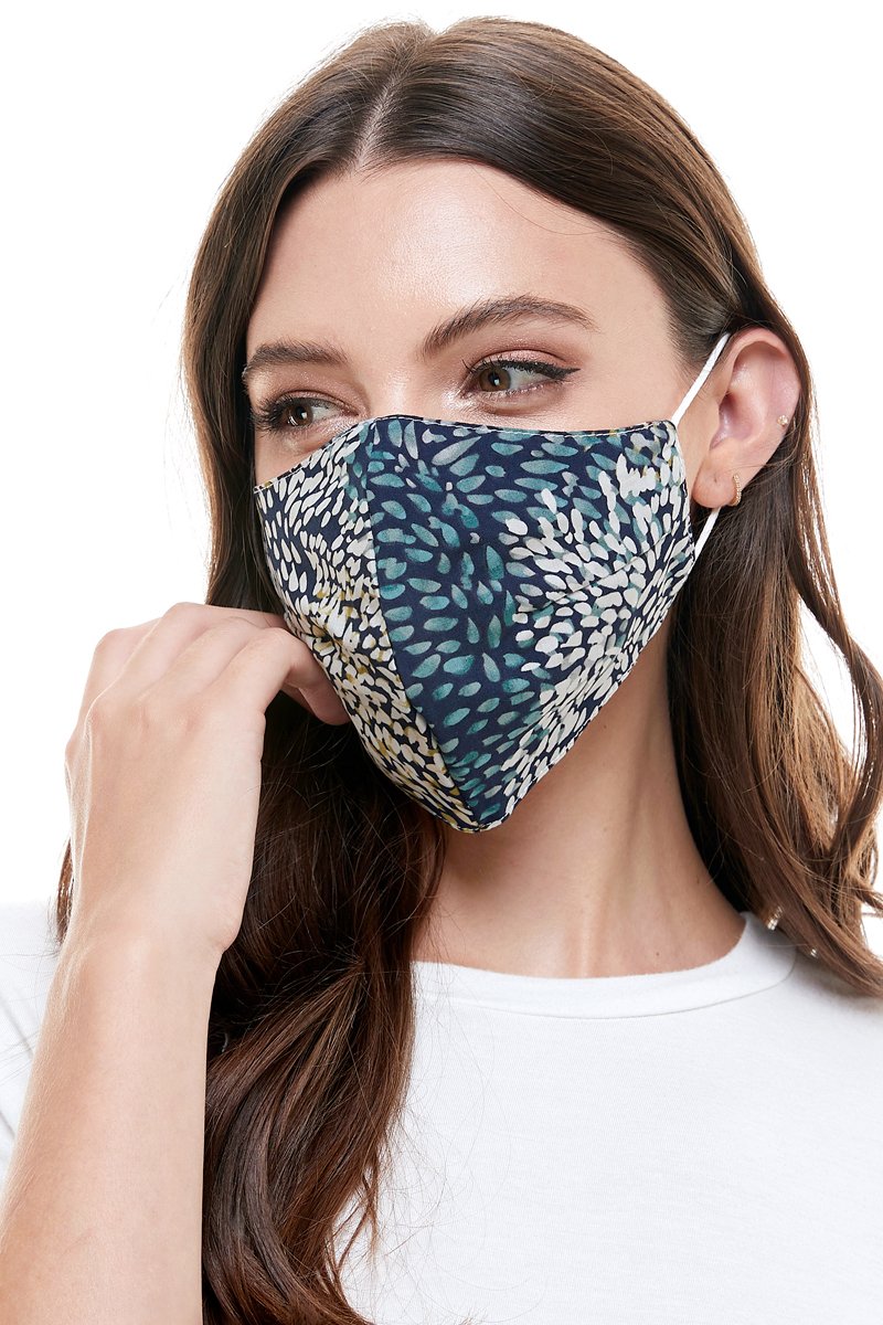 Reversible woven face mask featuring vibrant floral and tropical patterns, designed for comfort and safety.