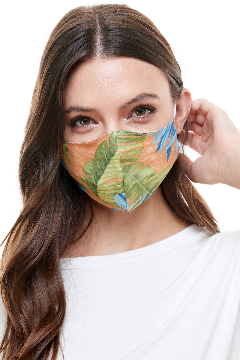 Reversible woven face mask featuring vibrant floral and tropical patterns, designed for comfort and safety.