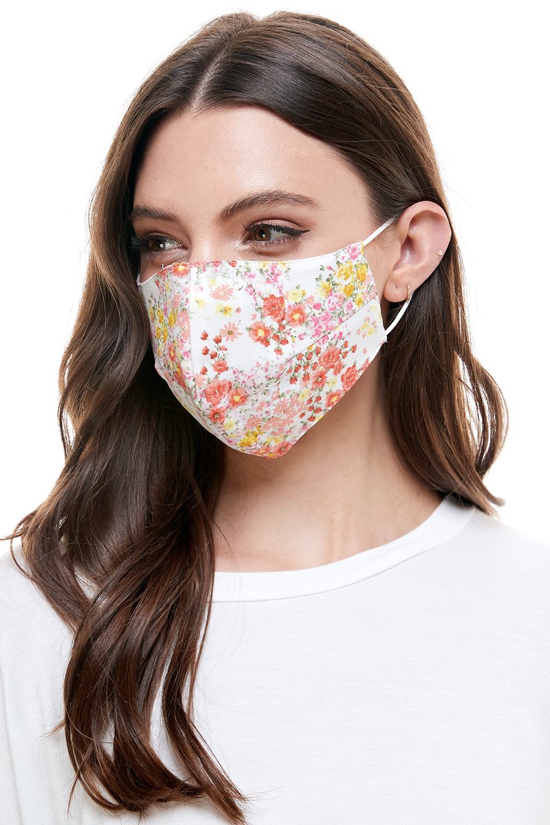 Reversible woven face mask featuring vibrant floral and tropical patterns, designed for comfort and safety.