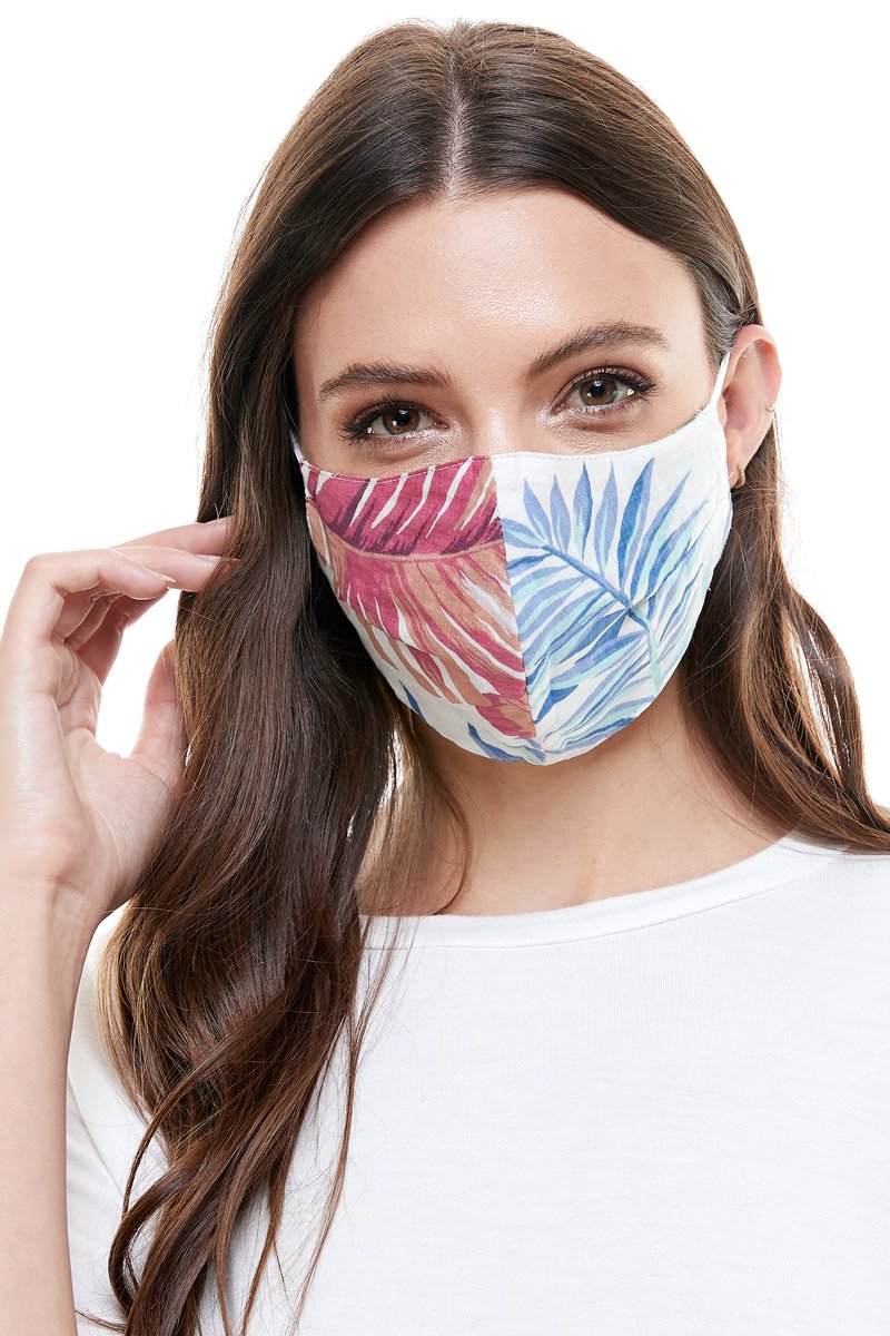 Reversible woven face mask featuring vibrant floral and tropical patterns, designed for comfort and safety.