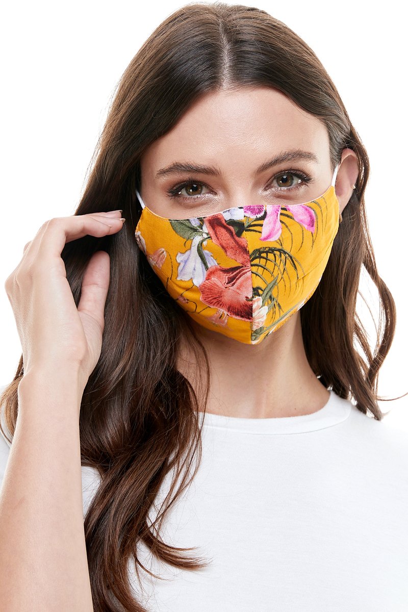 Reversible woven face mask featuring vibrant floral and tropical patterns, designed for comfort and safety.