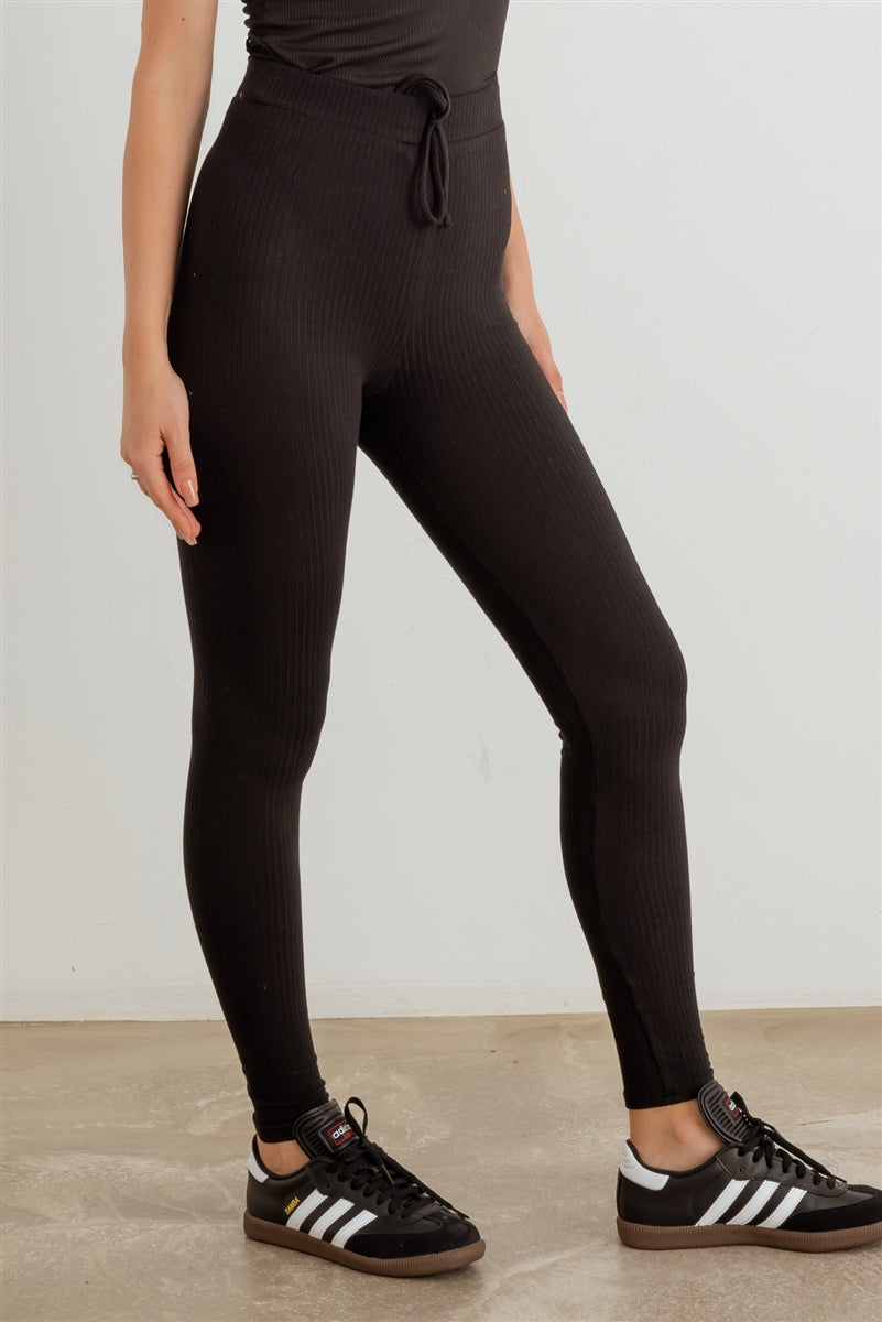 Ribbed high waist drawstring leggings in black, showcasing the elastic waist and stretchy fabric.