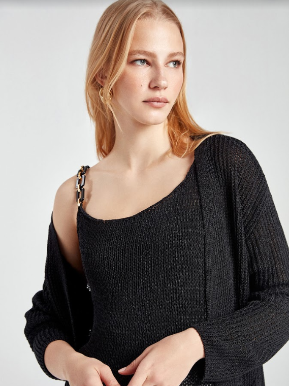 A stylish ribbed knit cardigan in a cozy mercerized fabric, featuring long sleeves and a front button closure, perfect for layering.