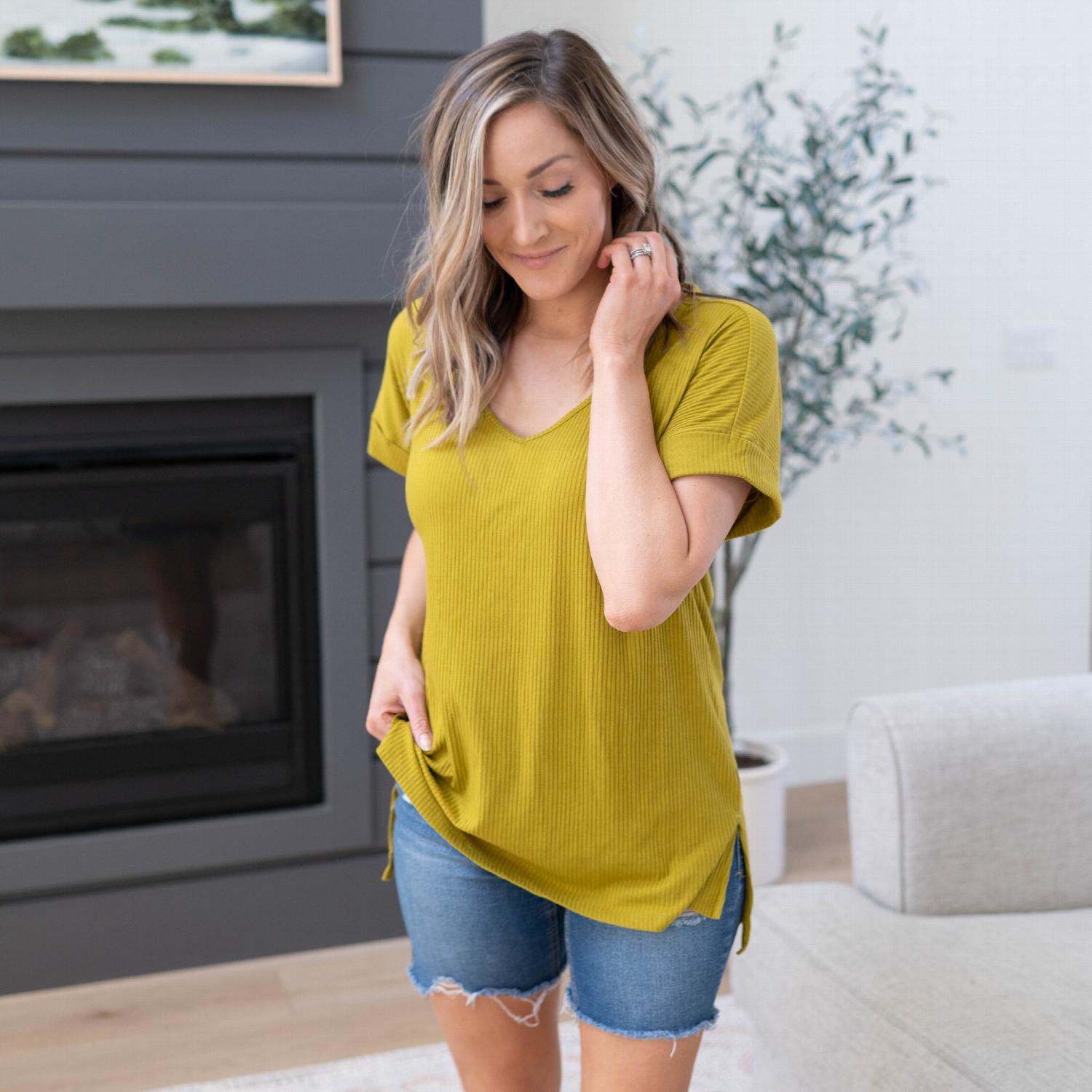 Ribbed V-neck Hi-low Hem Top with side slits, showcasing its stylish design and comfortable fit.