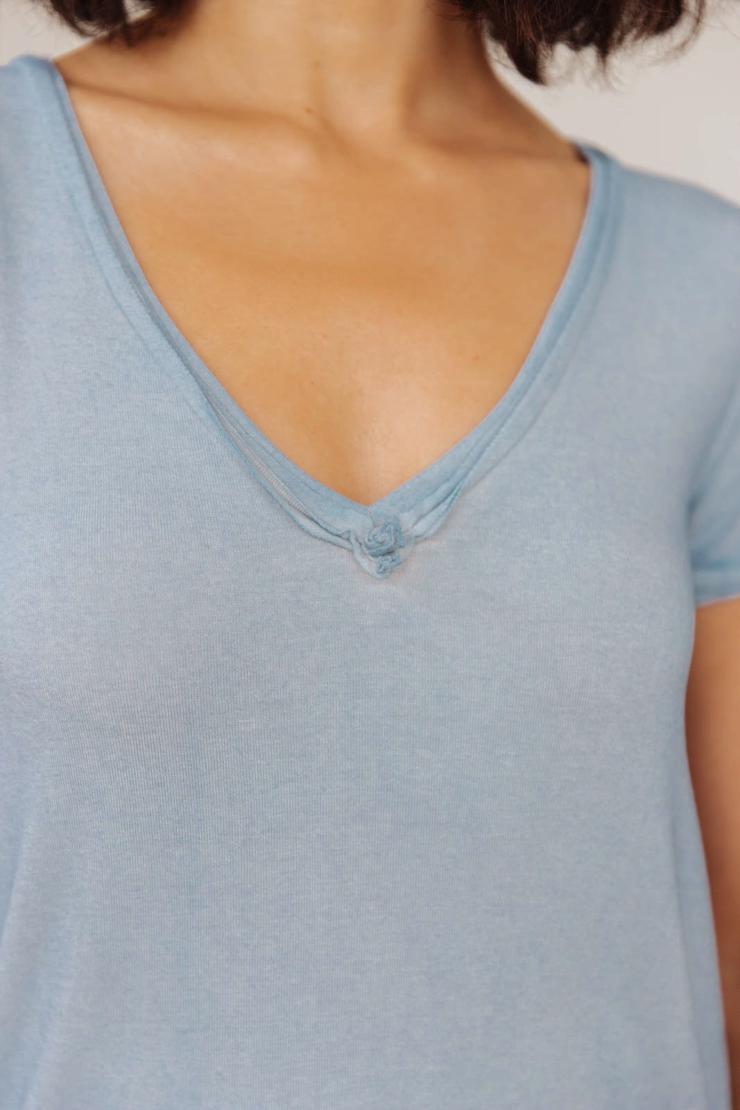 Right Side Out Top in Faded Blue featuring short sleeves and v-neckline with double fabric detail.