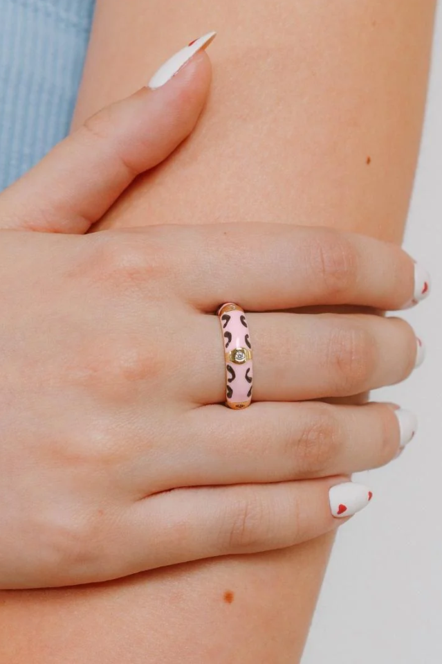 Elegant pink ring with intricate print and sparkling rhinestones, crafted from durable brass.