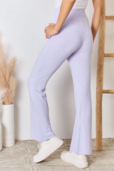 RISEN Full Size High Waist Ultra Soft Knit Flare Pants displayed on a model, showcasing their luxurious fabric and relaxed fit.