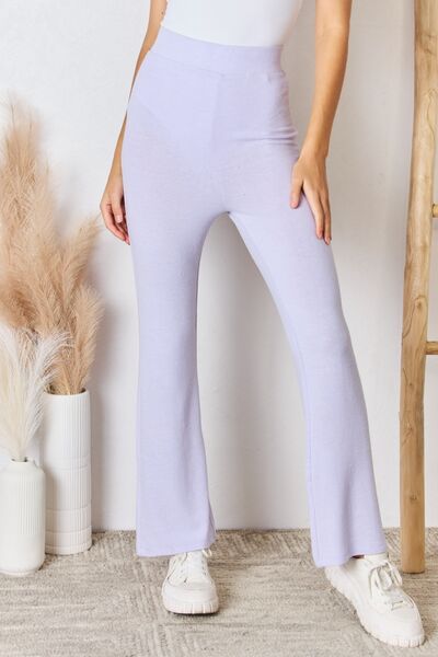 RISEN Full Size High Waist Ultra Soft Knit Flare Pants displayed on a model, showcasing their luxurious fabric and relaxed fit.