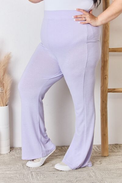 RISEN Full Size High Waist Ultra Soft Knit Flare Pants displayed on a model, showcasing their luxurious fabric and relaxed fit.