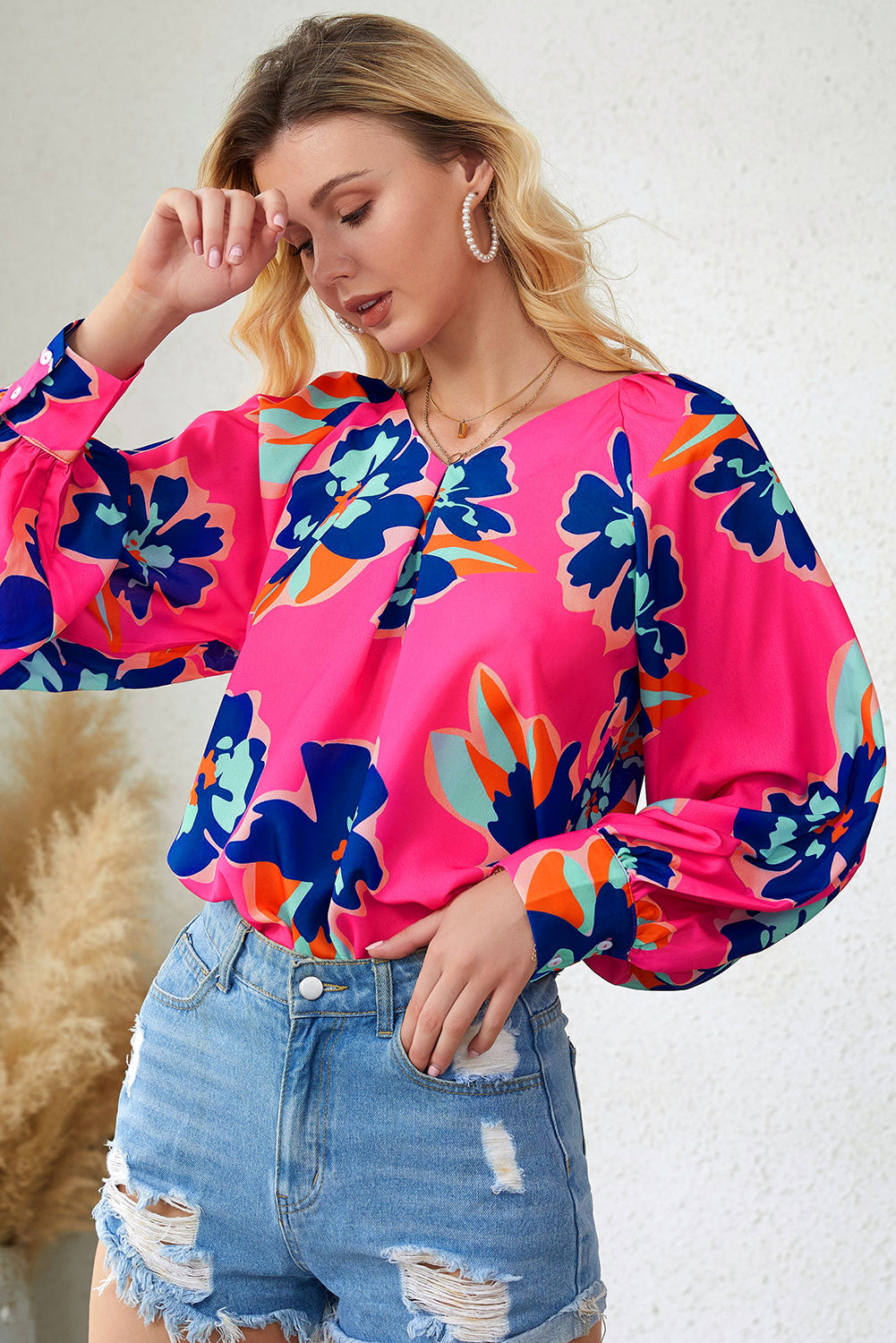 A stylish Rose Flower Puff Sleeve Blouse featuring a vibrant floral print, flattering V-neckline, and elegant long puff sleeves.