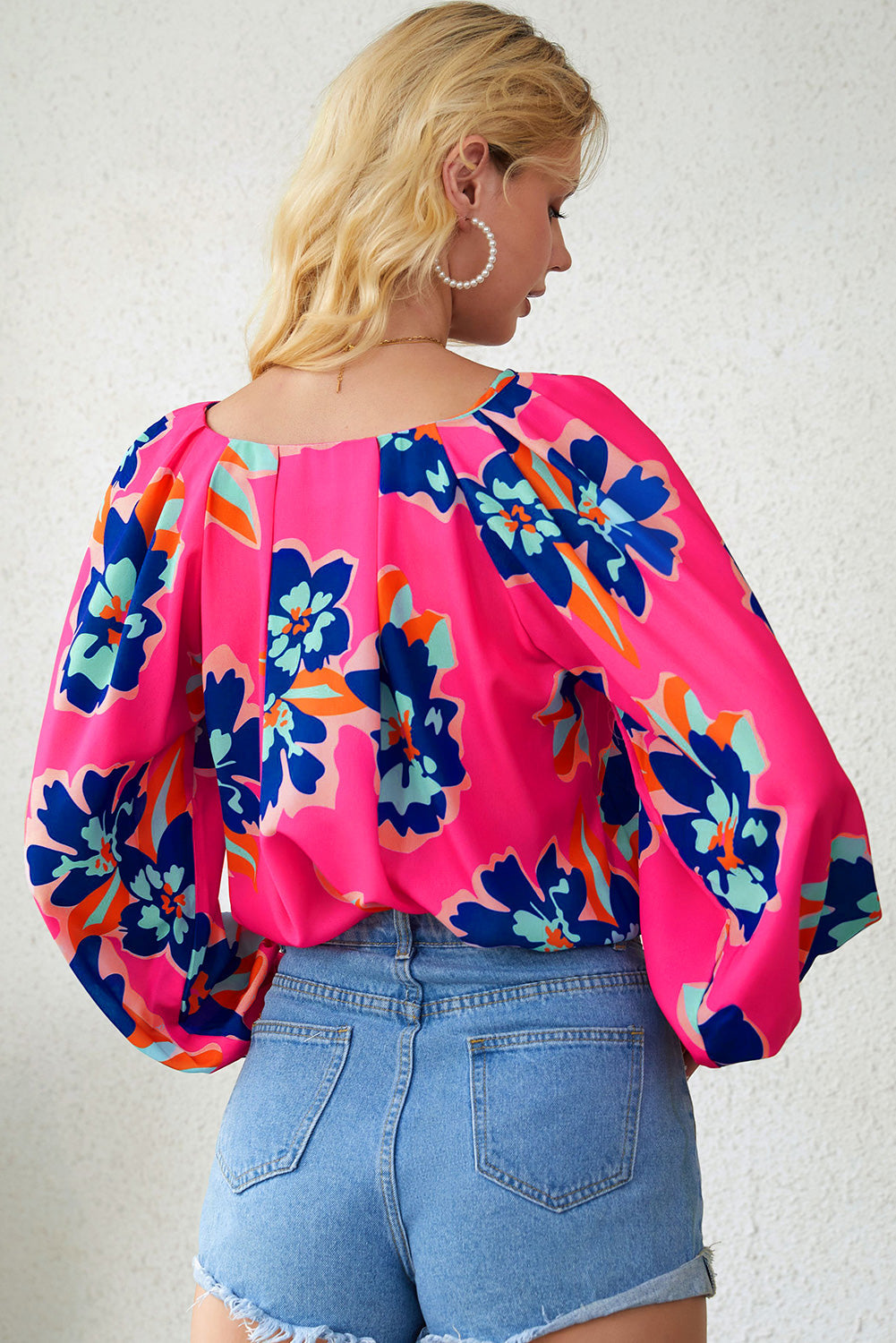 A stylish Rose Flower Puff Sleeve Blouse featuring a vibrant floral print, flattering V-neckline, and elegant long puff sleeves.