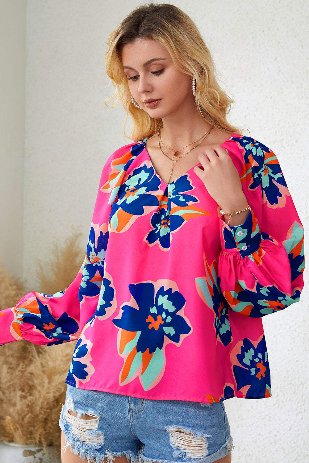 A stylish Rose Flower Puff Sleeve Blouse featuring a vibrant floral print, flattering V-neckline, and elegant long puff sleeves.