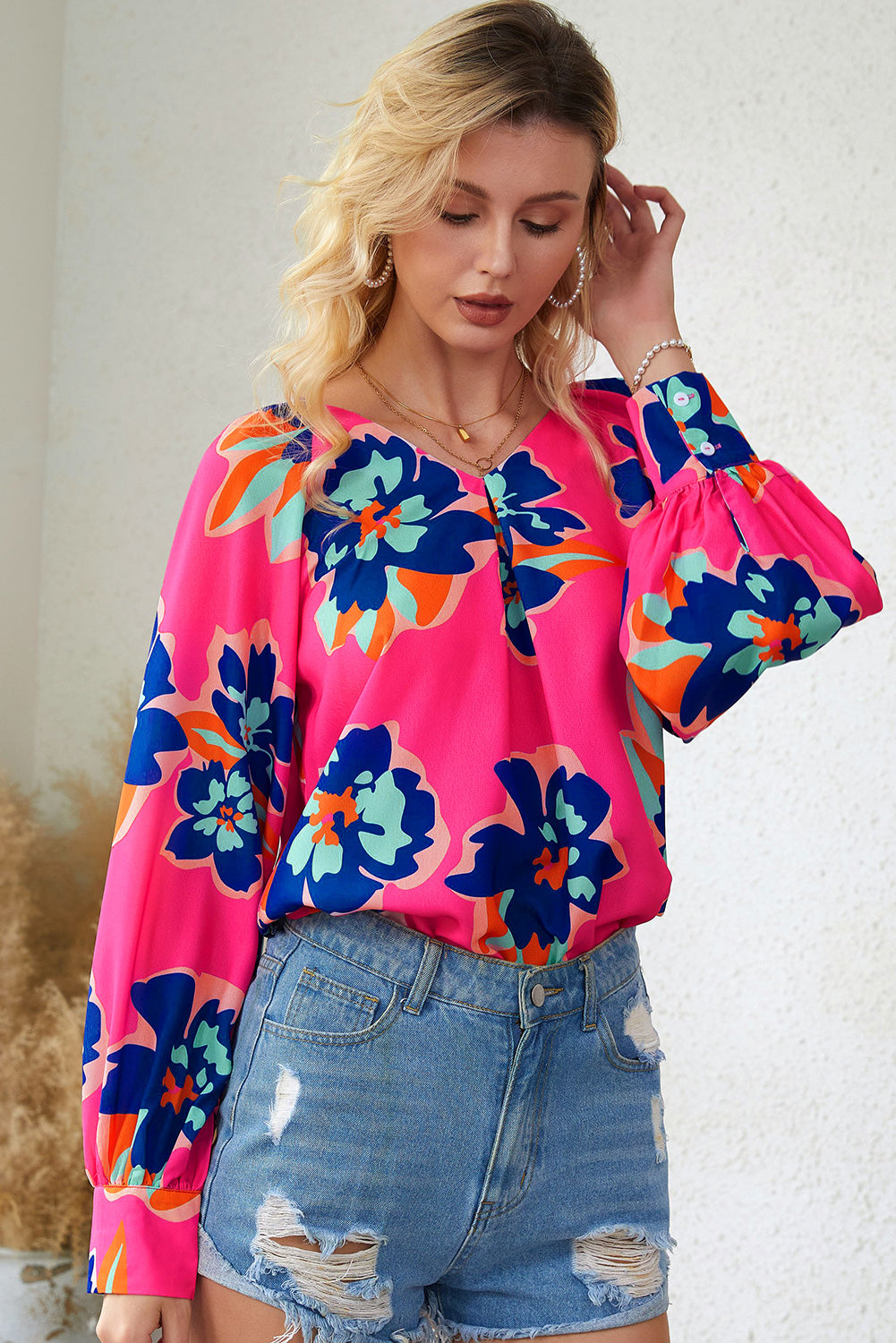 A stylish Rose Flower Puff Sleeve Blouse featuring a vibrant floral print, flattering V-neckline, and elegant long puff sleeves.