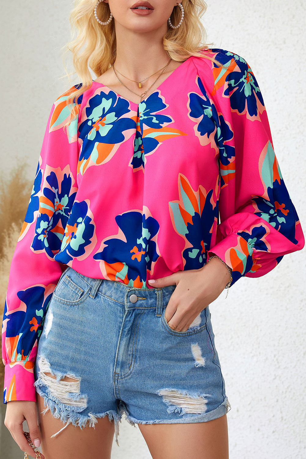 A stylish Rose Flower Puff Sleeve Blouse featuring a vibrant floral print, flattering V-neckline, and elegant long puff sleeves.