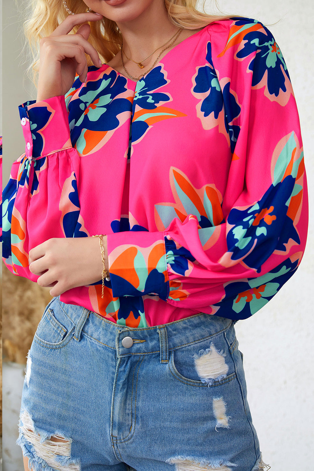 A stylish Rose Flower Puff Sleeve Blouse featuring a vibrant floral print, flattering V-neckline, and elegant long puff sleeves.