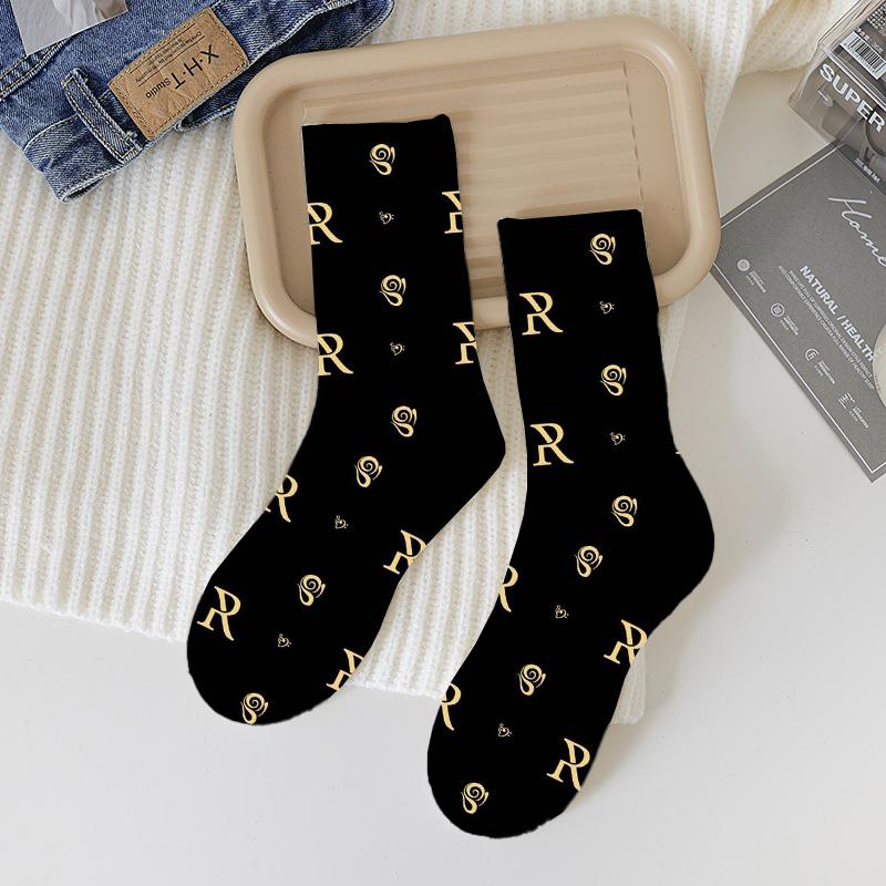 A set of three Rose Paulino Official Socks in classic colors, showcasing their cozy crew design, perfect for fall and Halloween.