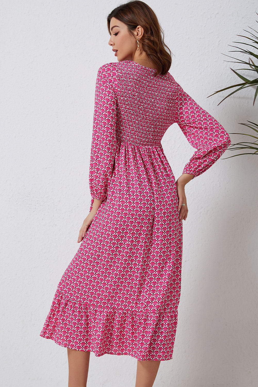 A beautiful long dress featuring a rose print, ruffled hem, and puff sleeves, perfect for feminine fashion styles.