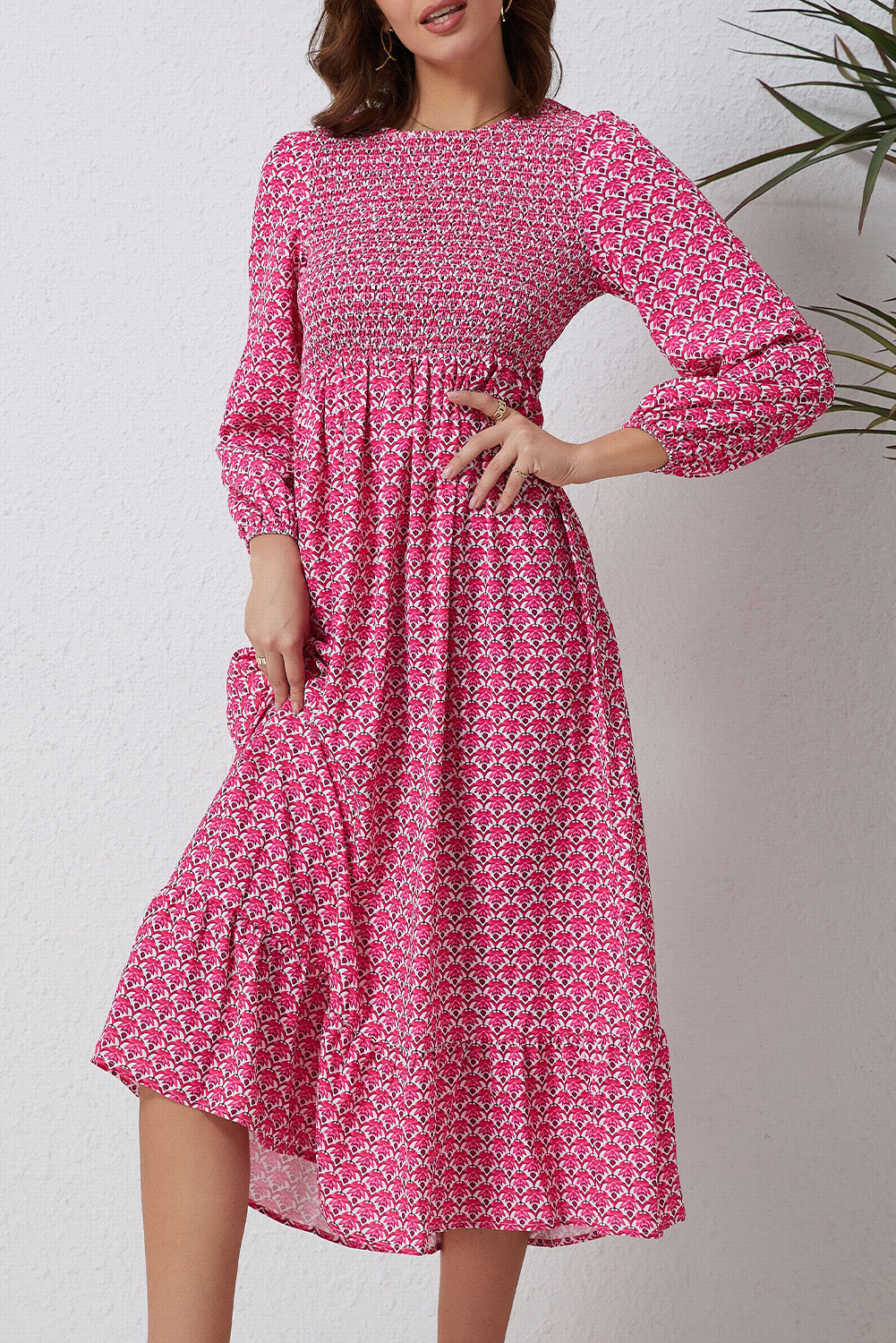 A beautiful long dress featuring a rose print, ruffled hem, and puff sleeves, perfect for feminine fashion styles.