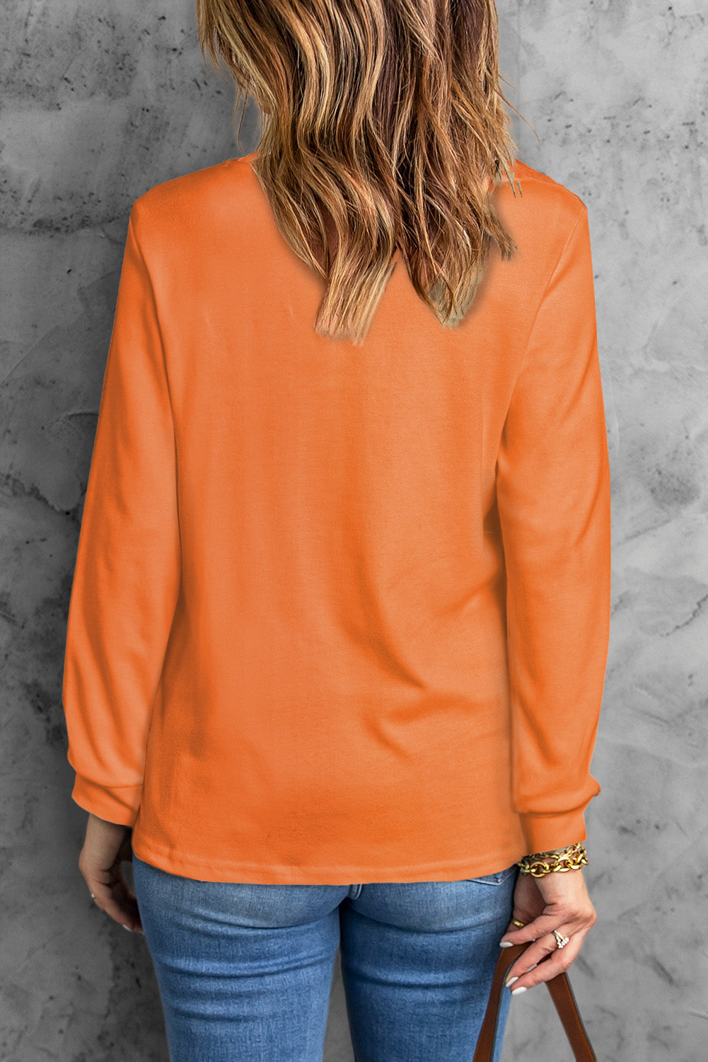 A stylish round neck long sleeve top in solid color, showcasing its casual design and comfortable fit.