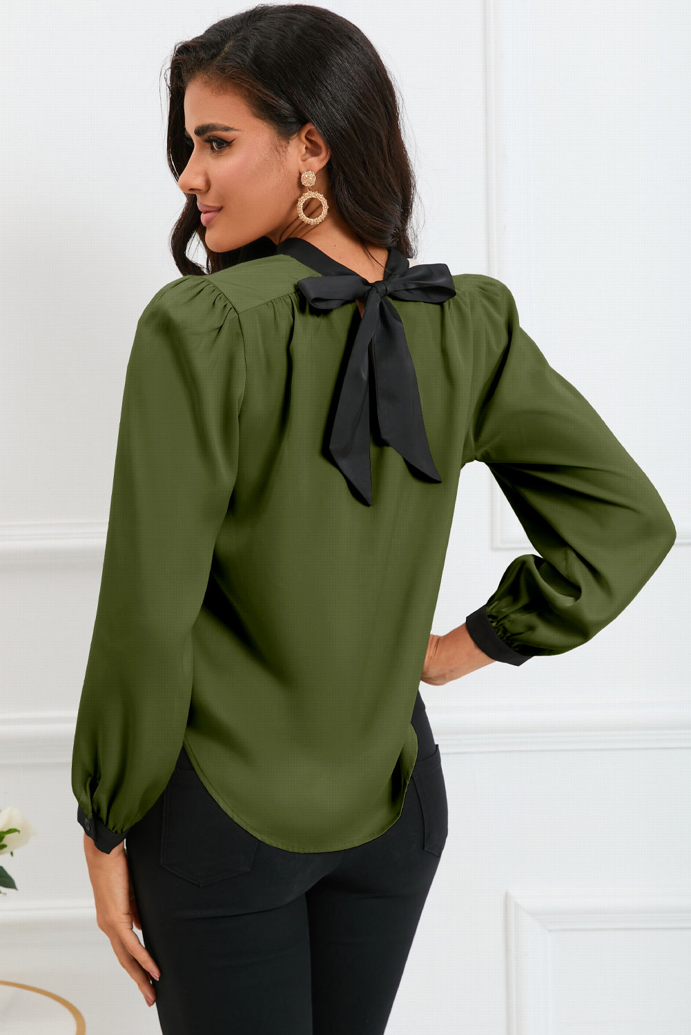 Round neck blouse with puff sleeves and back tie detail, showcasing a solid color design.