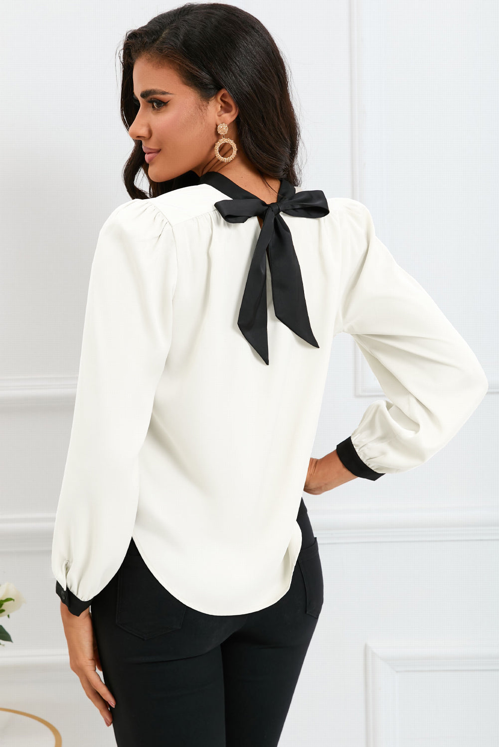 Round neck blouse with puff sleeves and back tie detail, showcasing a solid color design.