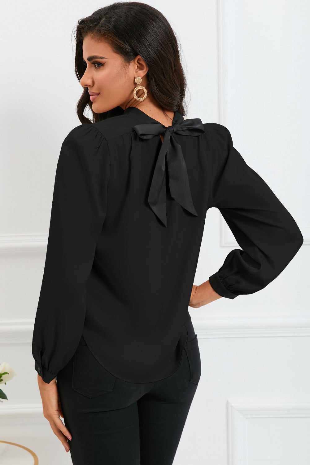 Round neck blouse with puff sleeves and back tie detail, showcasing a solid color design.