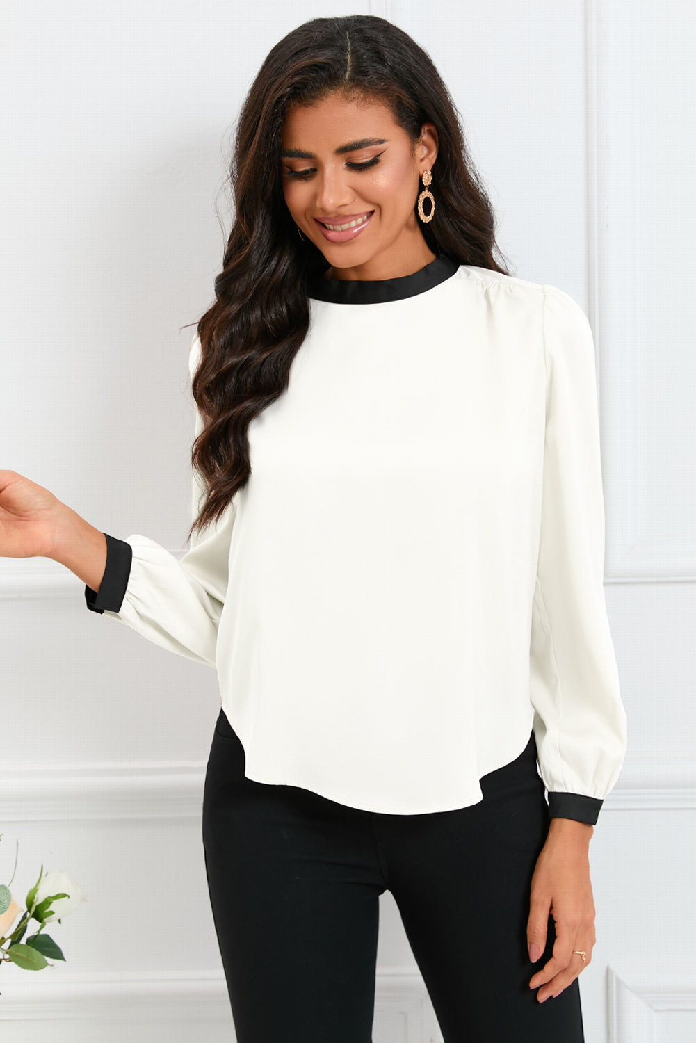 Round neck blouse with puff sleeves and back tie detail, showcasing a solid color design.