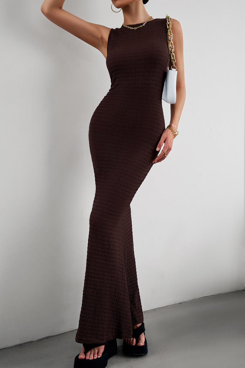 A stylish round neck sleeveless maxi fishtail dress in solid color, showcasing its elegant design and flowing silhouette.