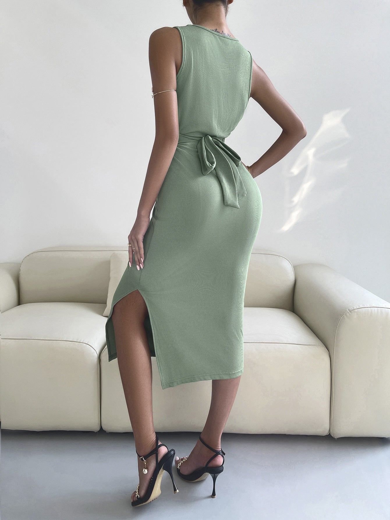 A stylish round neck tie back slit sleeveless dress in solid color, showcasing a chic design and flattering silhouette.