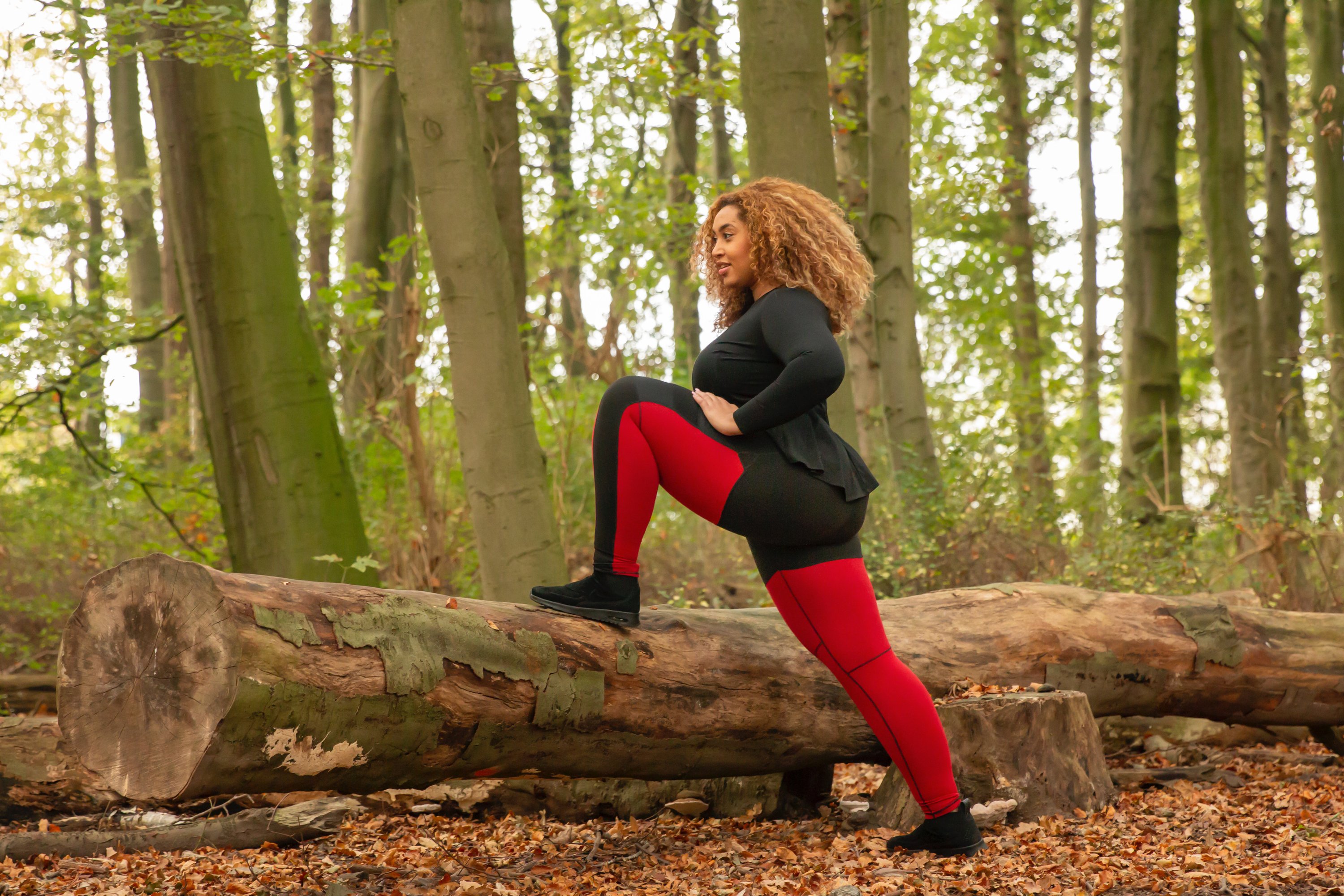 Round Red gym outfit for curvy women featuring padded support and stylish black leg details.