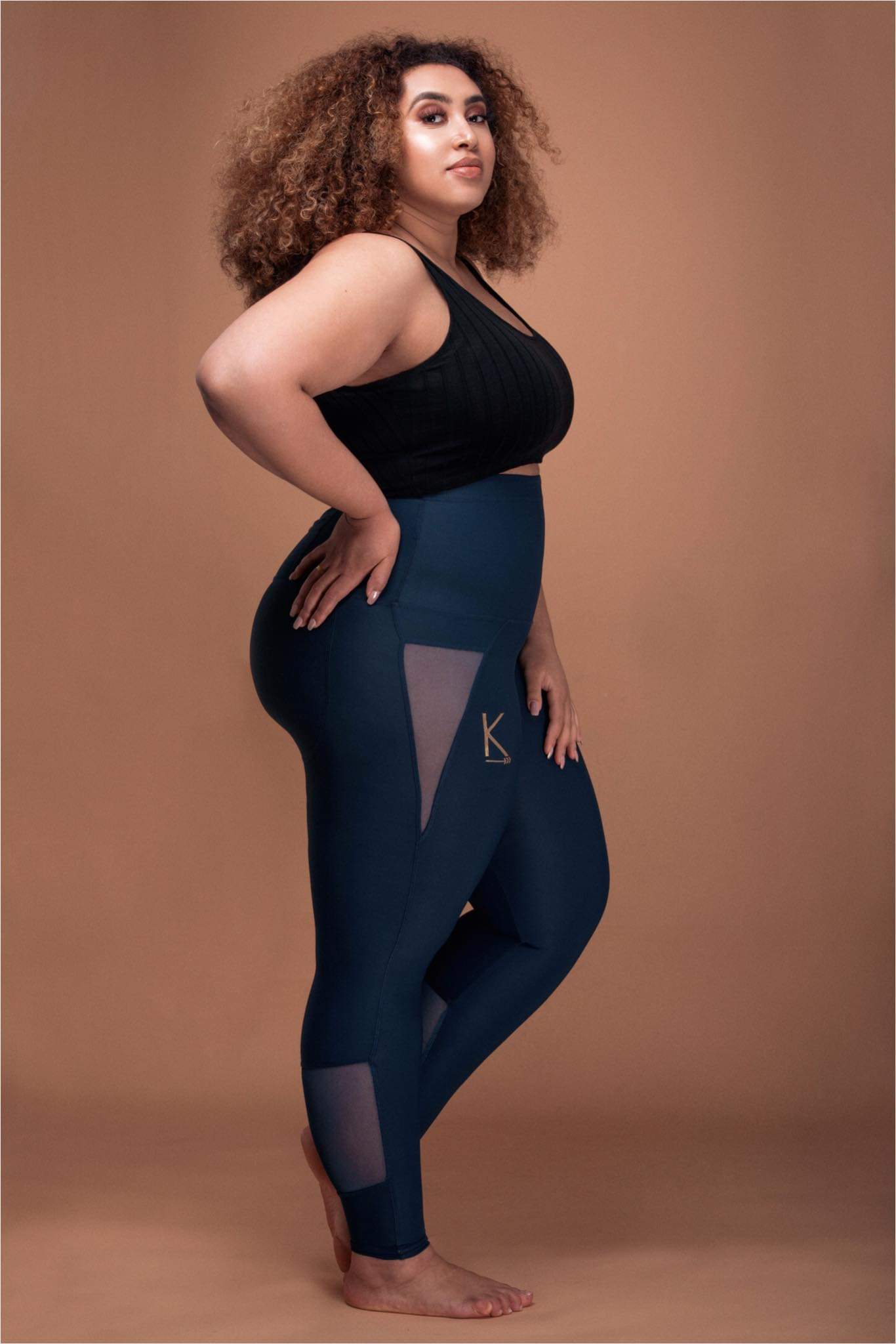 Royal blue high-waisted leggings with mesh accents and a back pocket, designed for comfort and style.