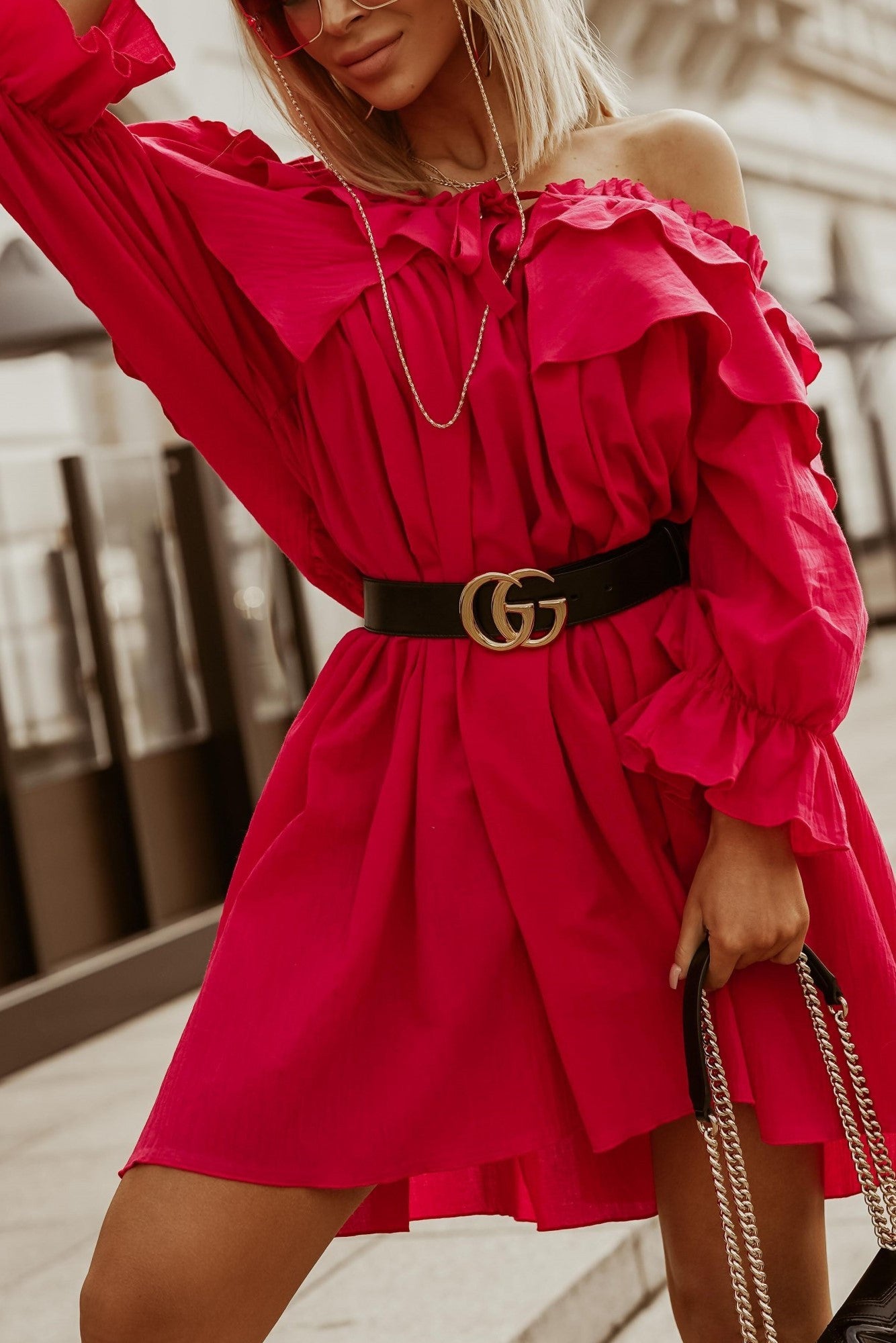 A fuchsia ruffled cotton mini dress with a bateau neckline and long sleeves, showcasing elegant lace and ruffles, perfect for various occasions.