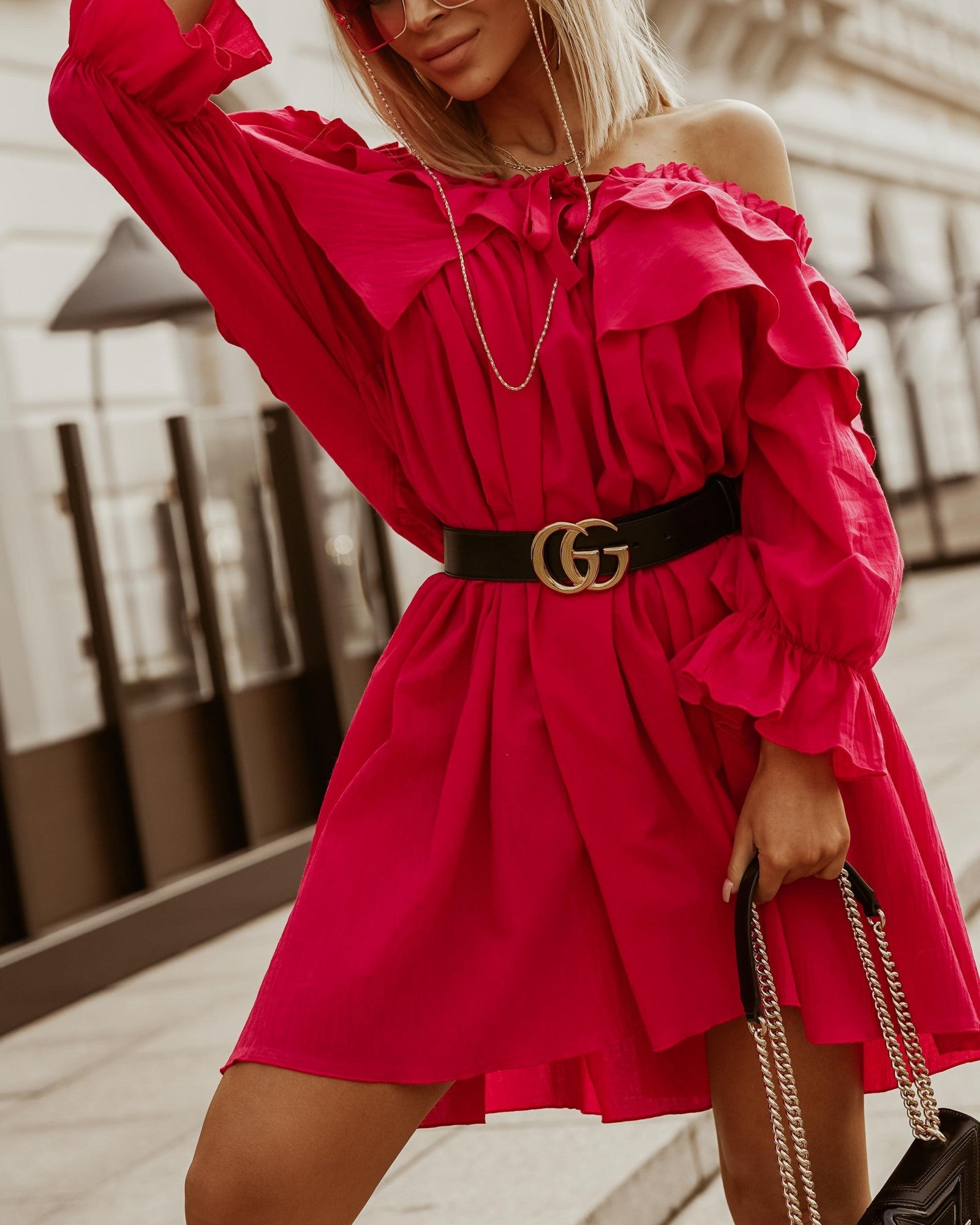 A fuchsia ruffled cotton mini dress with a bateau neckline and long sleeves, showcasing elegant lace and ruffles, perfect for various occasions.